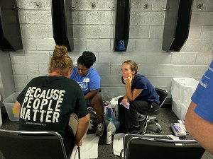 team members washing feet